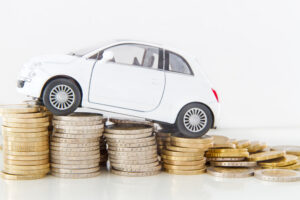 Tiny car climbs coin stacks