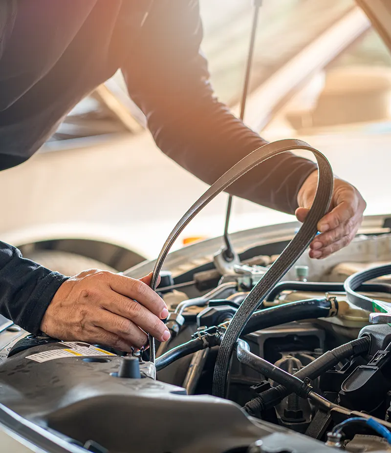 auto mechanic swapping out a belt